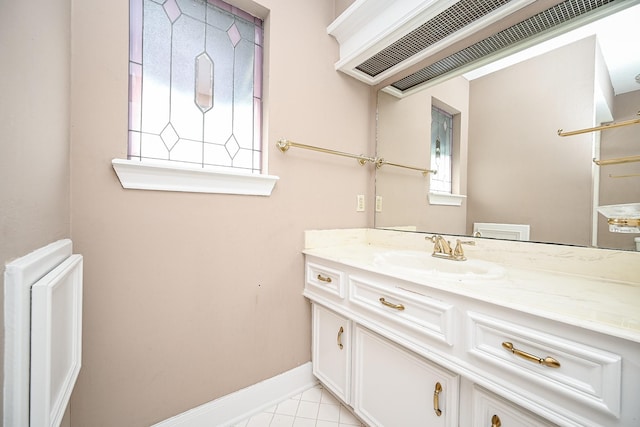 bathroom with tile patterned flooring, vanity, and baseboards