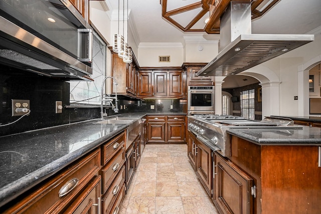 kitchen with arched walkways, island range hood, visible vents, appliances with stainless steel finishes, and ornamental molding