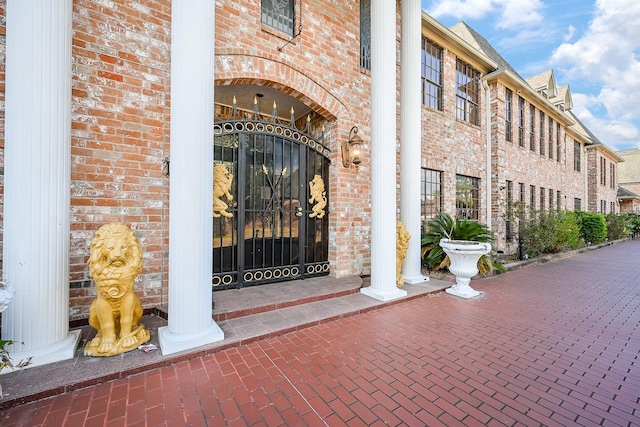 doorway to property featuring brick siding