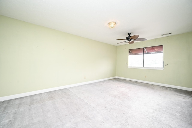 empty room with visible vents, baseboards, and a ceiling fan