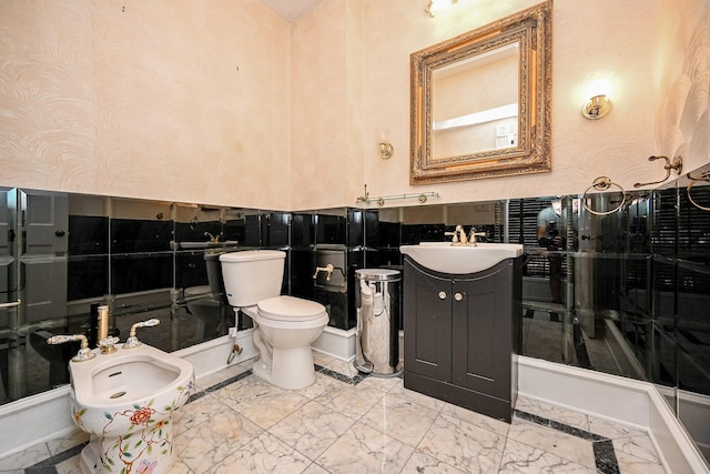 bathroom featuring marble finish floor, toilet, a bidet, vanity, and wallpapered walls