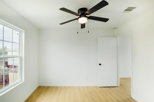 spare room featuring visible vents, baseboards, and light wood-style flooring