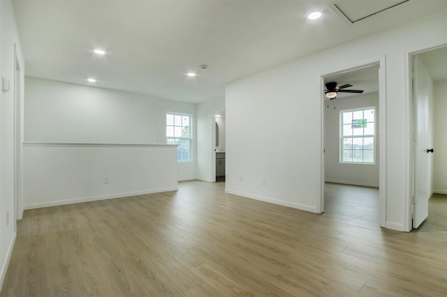 empty room with recessed lighting, baseboards, and light wood-style floors