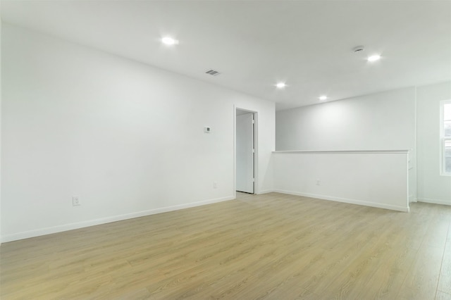 spare room featuring recessed lighting, light wood-type flooring, baseboards, and visible vents