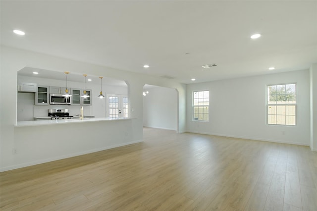 unfurnished living room with recessed lighting, visible vents, and light wood-style flooring