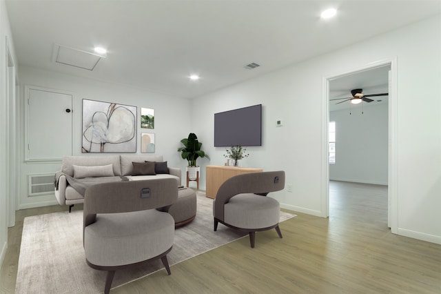 living area with recessed lighting, visible vents, light wood-style flooring, and attic access