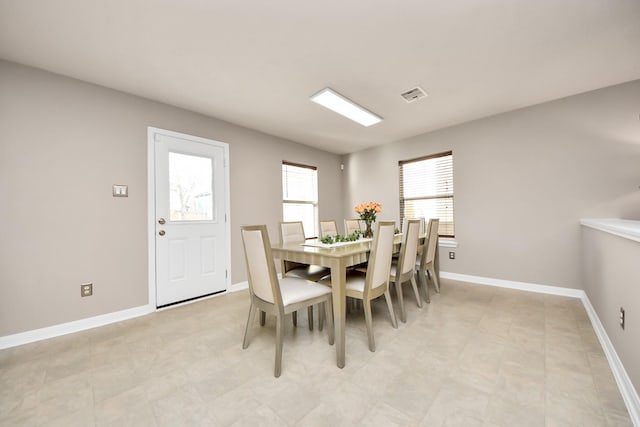 dining space featuring visible vents and baseboards