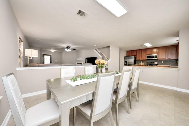 dining room with visible vents, ceiling fan, and baseboards