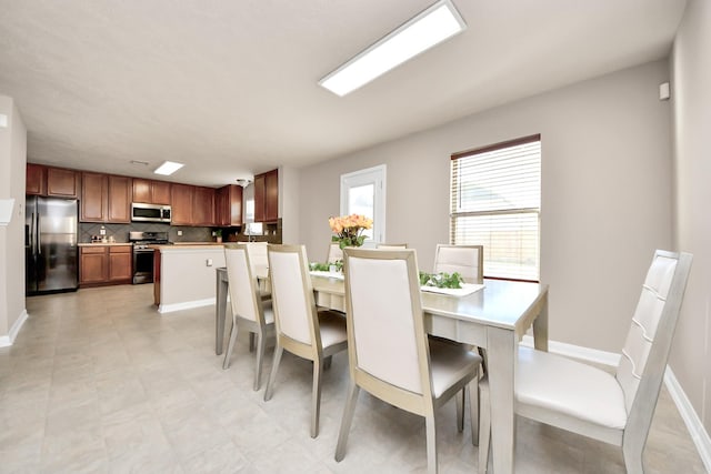 dining area featuring baseboards