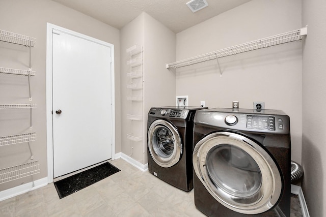 laundry area with washer and dryer, laundry area, visible vents, and baseboards