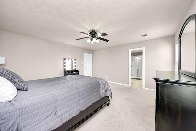 bedroom with light carpet, visible vents, baseboards, ceiling fan, and a textured ceiling