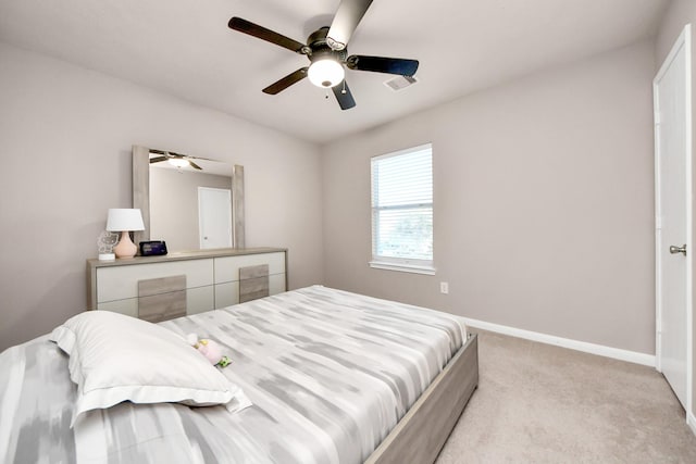 bedroom featuring baseboards, visible vents, ceiling fan, and light colored carpet