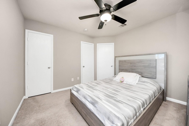 bedroom with a ceiling fan, baseboards, visible vents, and carpet flooring