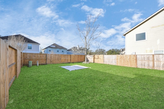 view of yard with a fenced backyard