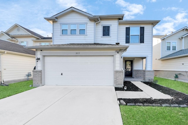 view of front of property with a garage, brick siding, and driveway