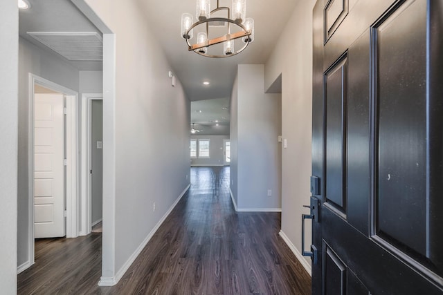 interior space featuring dark wood-style floors, baseboards, a chandelier, and recessed lighting