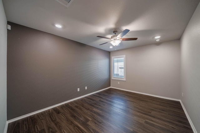 spare room with ceiling fan, recessed lighting, visible vents, baseboards, and dark wood finished floors