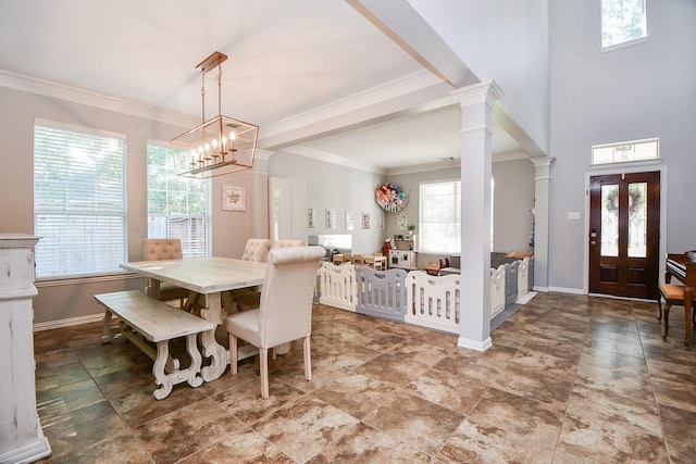 dining area with ornamental molding, baseboards, and ornate columns