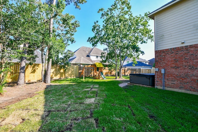 view of yard with a playground and a fenced backyard