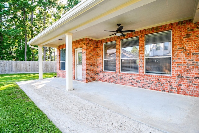 view of patio / terrace with fence and a ceiling fan