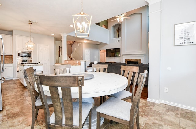 dining space with light tile patterned floors, visible vents, baseboards, stairs, and an inviting chandelier