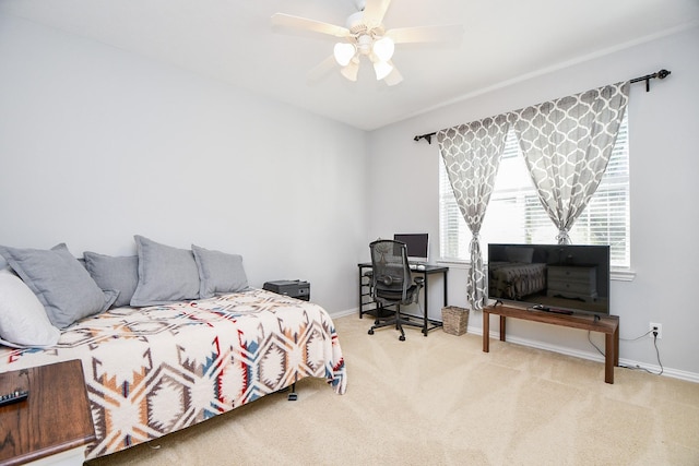 carpeted bedroom with a ceiling fan and baseboards