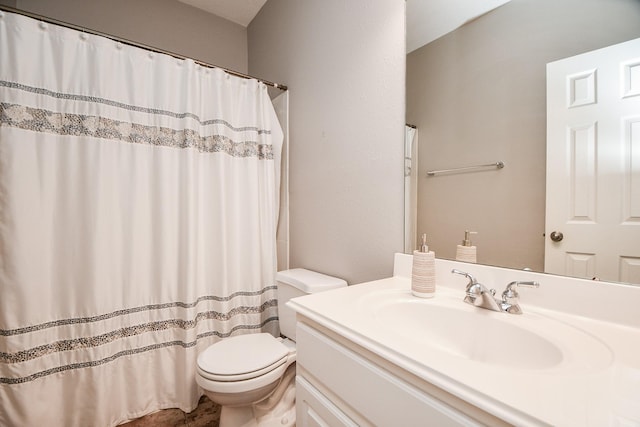 bathroom featuring a shower with curtain, vanity, and toilet