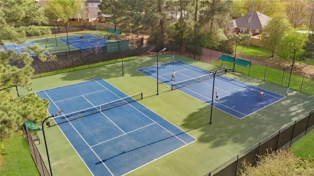 view of sport court featuring fence