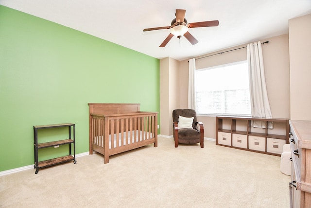 bedroom with baseboards, ceiling fan, and light colored carpet