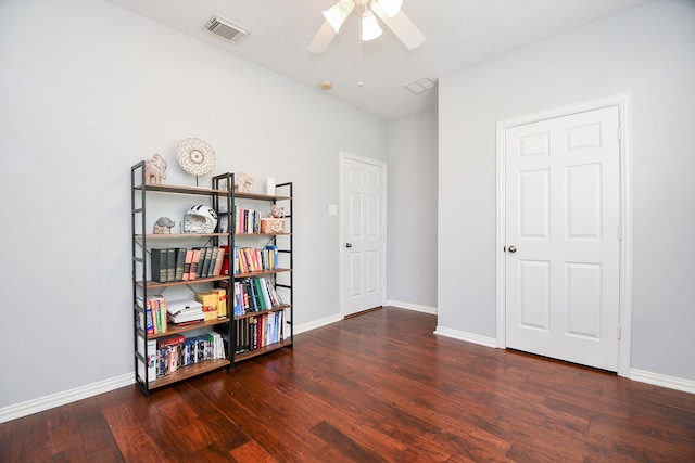 sitting room with baseboards, visible vents, and wood finished floors