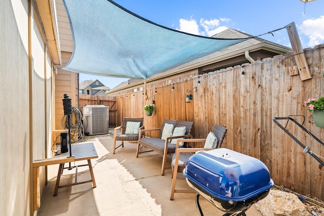 view of patio / terrace featuring fence, area for grilling, and central air condition unit