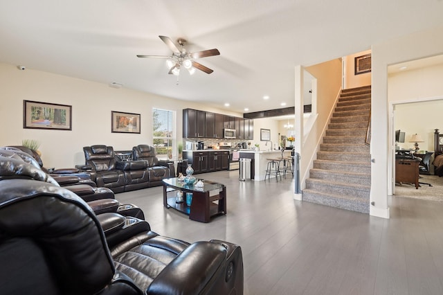 living area with ceiling fan, stairs, wood finished floors, and recessed lighting