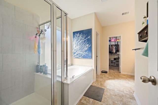 bathroom with baseboards, a shower stall, visible vents, and a bath