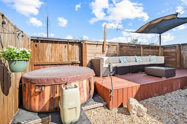 deck featuring a hot tub, an outdoor living space, and a fenced backyard