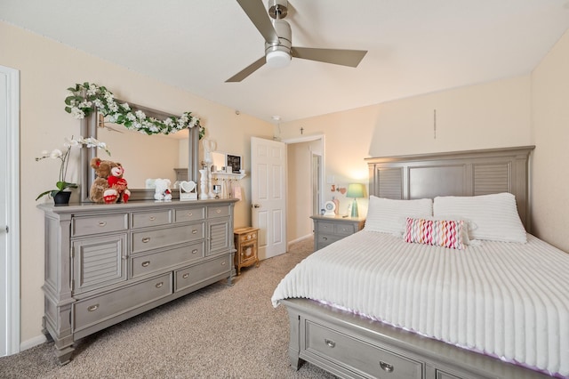 bedroom featuring light carpet, ceiling fan, and baseboards