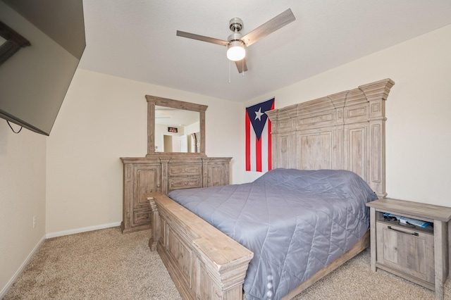 bedroom featuring a ceiling fan, light colored carpet, and baseboards