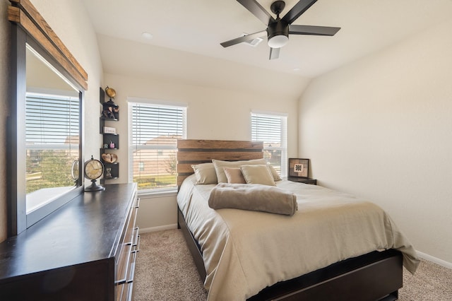 carpeted bedroom with vaulted ceiling, ceiling fan, and baseboards