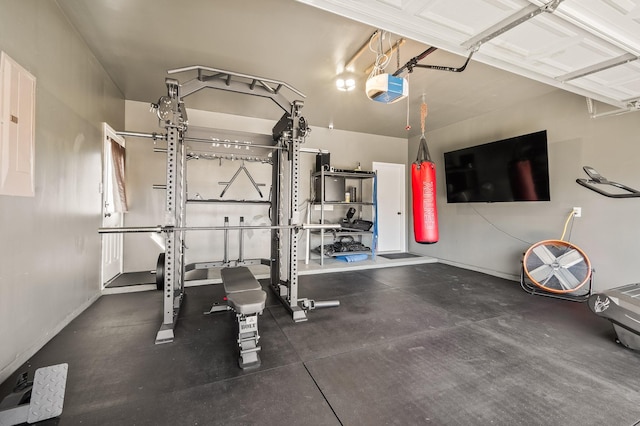 workout room with a garage, electric panel, and baseboards