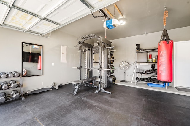 exercise room with a garage and electric panel