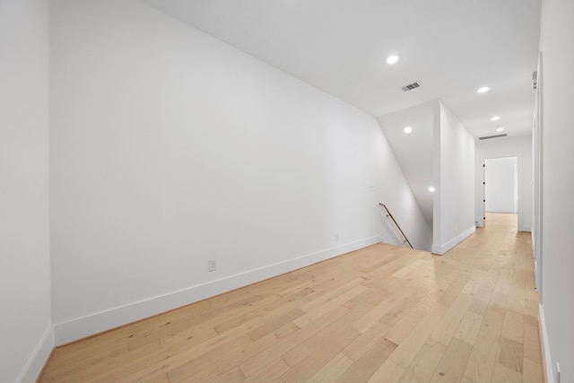 spare room featuring baseboards, light wood finished floors, visible vents, and recessed lighting