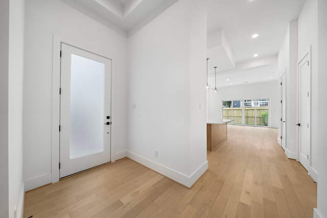 entryway featuring baseboards, light wood-type flooring, and recessed lighting