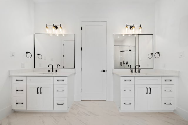 bathroom with marble finish floor, a stall shower, two vanities, and a sink