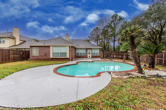 view of pool with a fenced in pool, a patio area, a fenced backyard, and a lawn