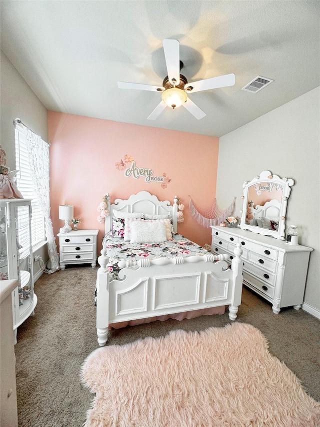 bedroom with carpet, visible vents, and ceiling fan