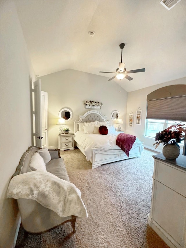 carpeted bedroom with lofted ceiling, ceiling fan, and visible vents