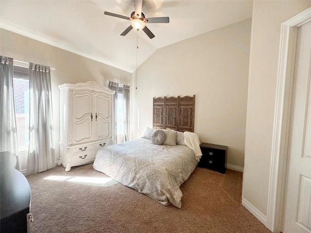 bedroom with lofted ceiling, light carpet, a ceiling fan, and baseboards