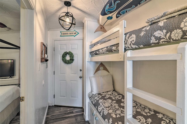 mudroom with ornamental molding and dark wood-style flooring