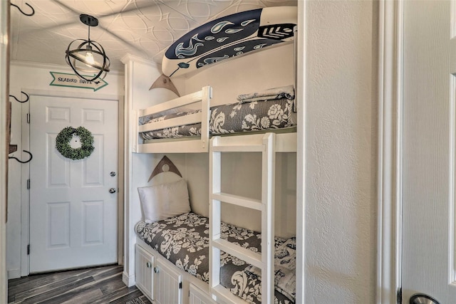 mudroom featuring a textured wall and dark wood-style flooring