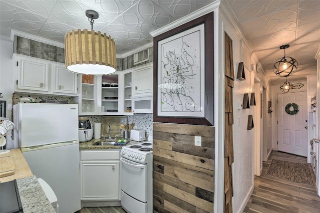 kitchen with white appliances, a sink, white cabinets, open shelves, and an ornate ceiling