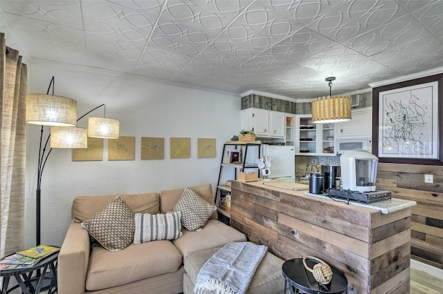 living area with ornamental molding and an ornate ceiling